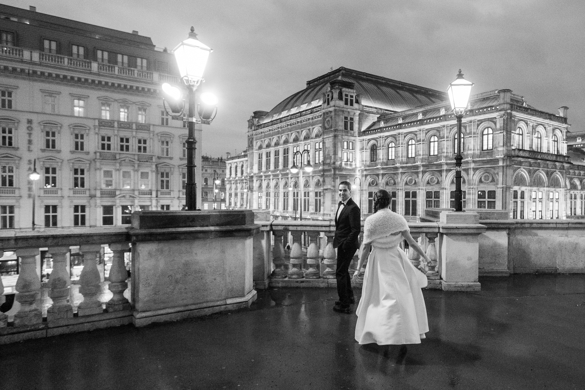 Bride and groom at Albertina terrace with view over the Opera House in Vienna